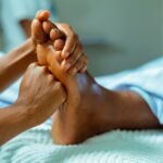 a person laying in a bed with their feet up